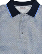 A classic white polo with a neatly printed blue shaded medallion pattern creates a traditional look coupled with a casual or dress image.  Soft, rich cotton fabric with a fine pique finish.  Matched collar and hand selected buttons.  Classic fit.