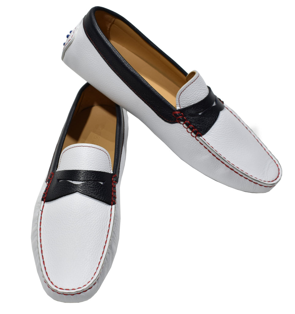 Choose this outstanding leather driver in fashionable white natural grain leather, accented with navy leather and cool red stitching. Featuring a royal blue gommini effect sole.   Soft foot bed for added comfort and a classic fit.  Designed and manufactured in Spain. White leather shoe by Marcello.