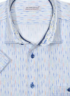 A unique brushed stripe with accentuated colors, on soft cotton fabric, welcomes the Spring/Summer season. To enhance the look the stiching is double track and in a contrast color. Fashion trim fabric, neck piping and a classic buttoned chest pocket add to the look. Classic shaped fit. Shirt by Marcello Sport.