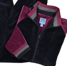 Fashion style in a velour microfiber fabric featuring a black top with wine accent color down the shoulders and sleeves, with a knitted collar, cuff and waist band matching the body colors.  Cool leisure set model with a dressy super soft feel.  The top features classic side slash pockets.  Classic draw string pant with stretch waist band, and regular pocket detailing.  Classic fit.