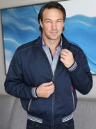 G. Ferrinni exlcusive, nautical themed wind breaker. The true navy coloration in this microfiber jacket sports an updated look and nautical feel.  Sharp contrasting color detailing finish the look.  Classic knit banded cuffs and waistband.  Classic fit, imported by Marcello Sport.